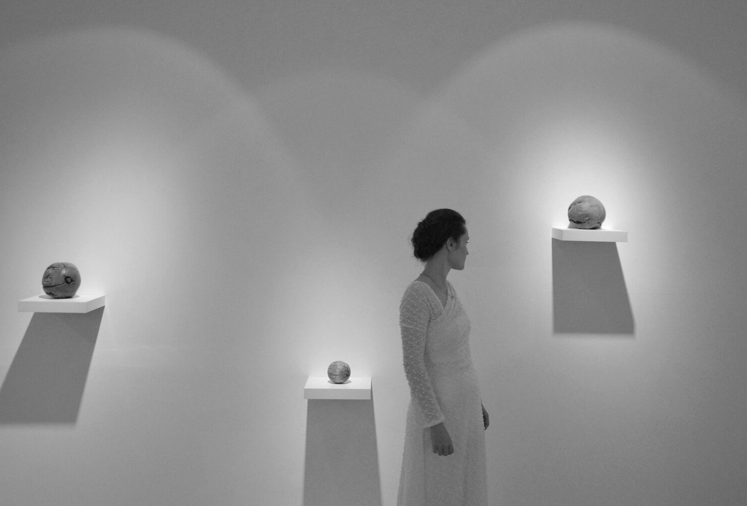 Diana Popuț between three sculptural spheres at AnnArt Gallery, 2025